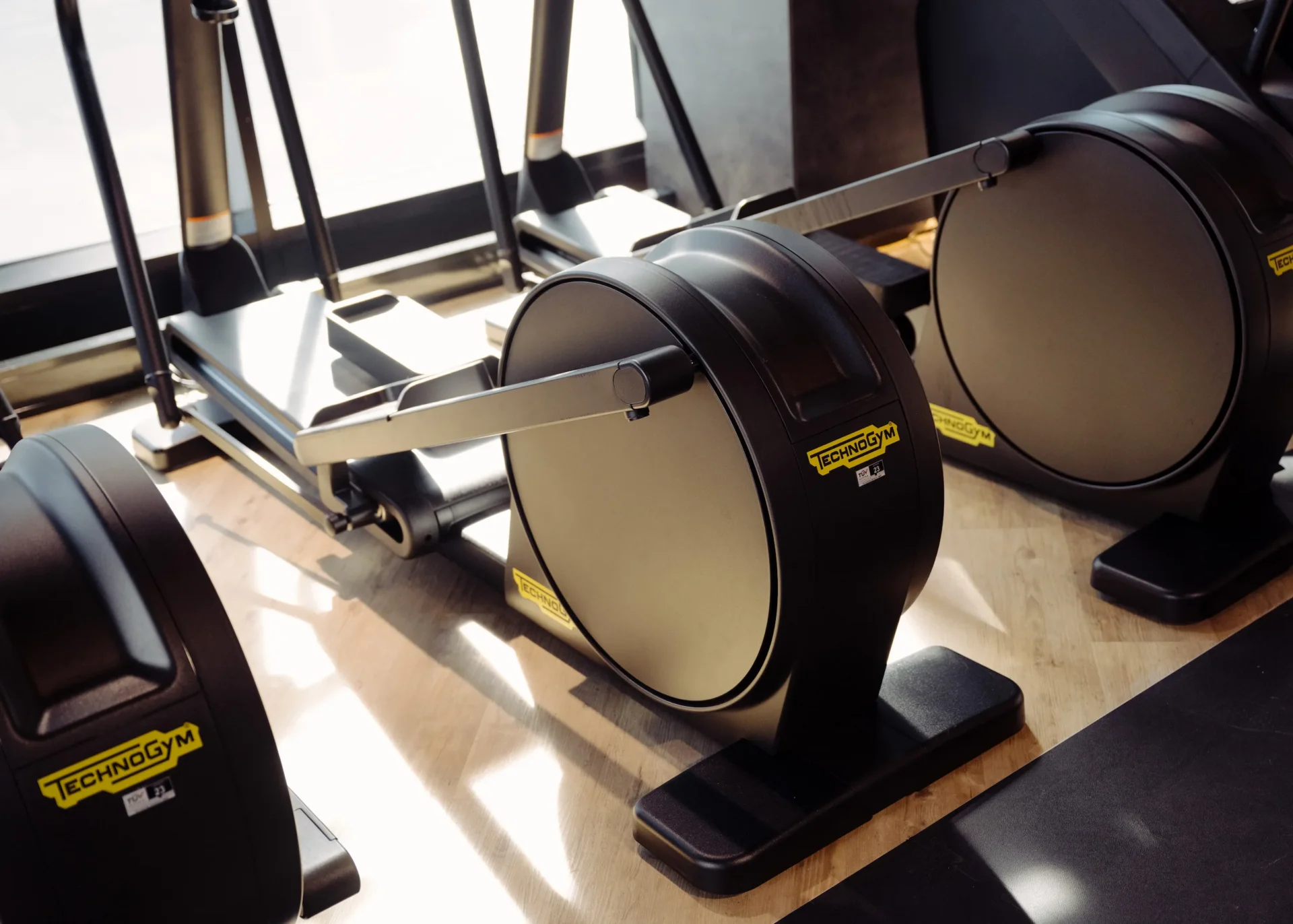 Technogym elliptical machines close-up on studio floor at EVO Fitness