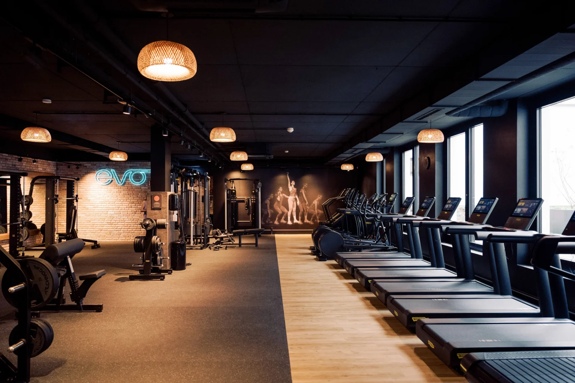EVO Fitness gym with treadmills, strength machines and ambient lighting
