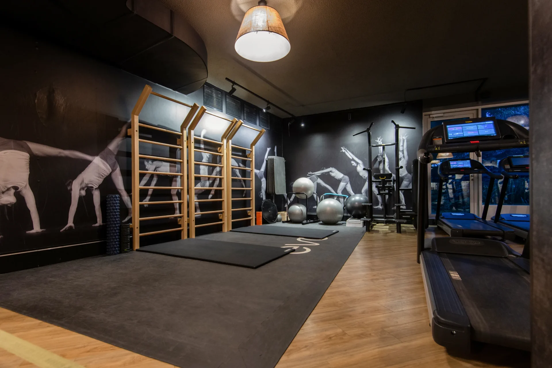 Stretch and equipment area with swedish ladder and treadmills