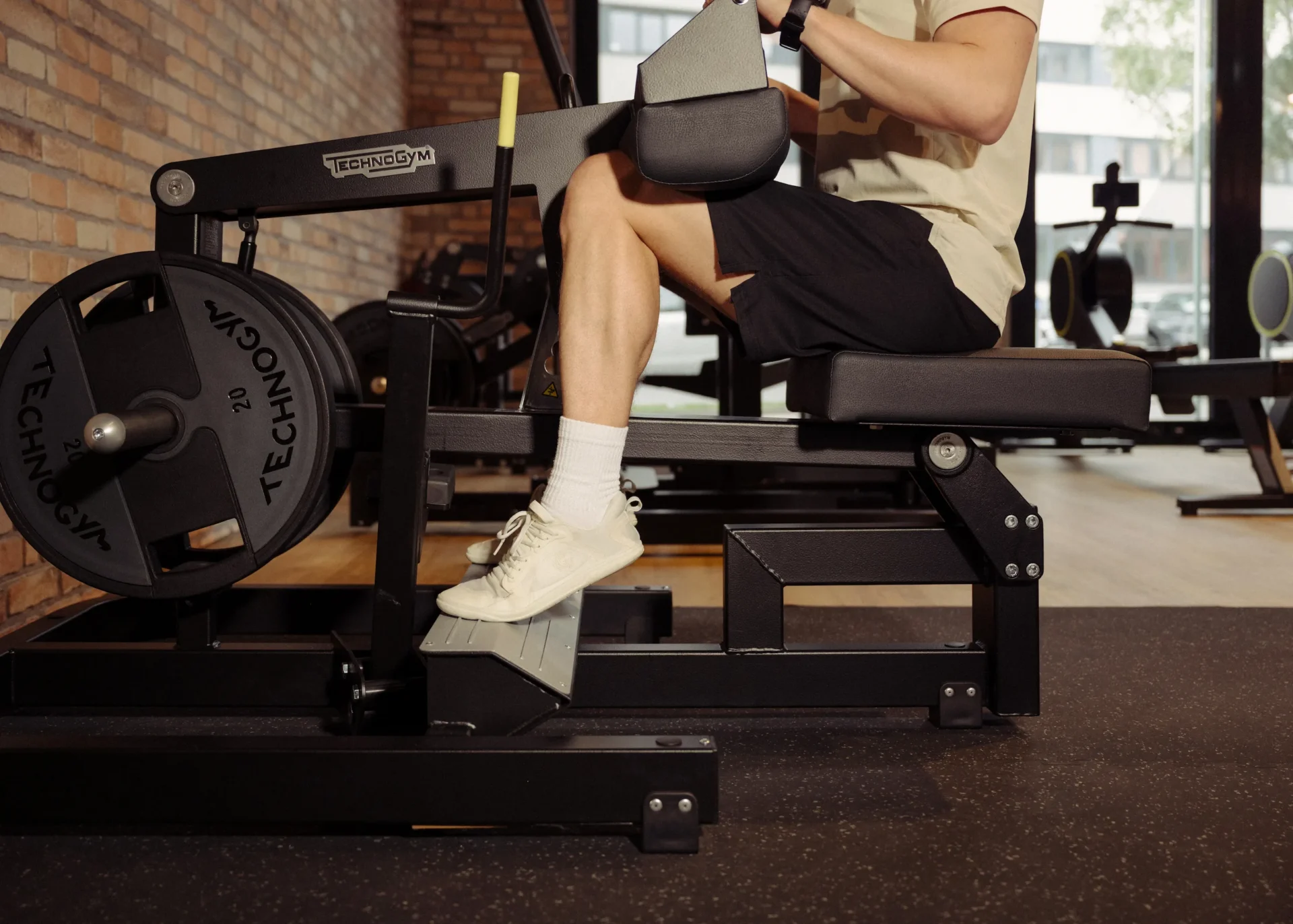 Man using Technogym leg press machine during workout at EVO Fitness