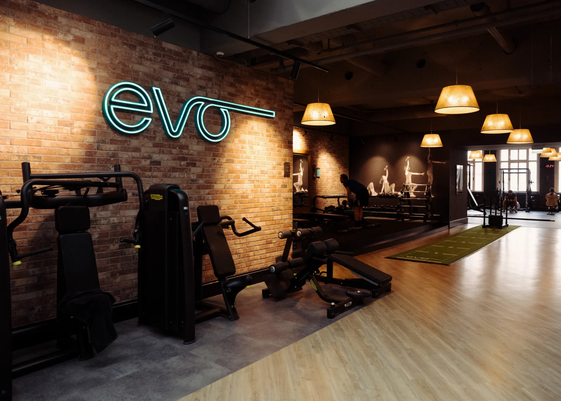 Wide view of EVO gym with training zones and exposed brick walls