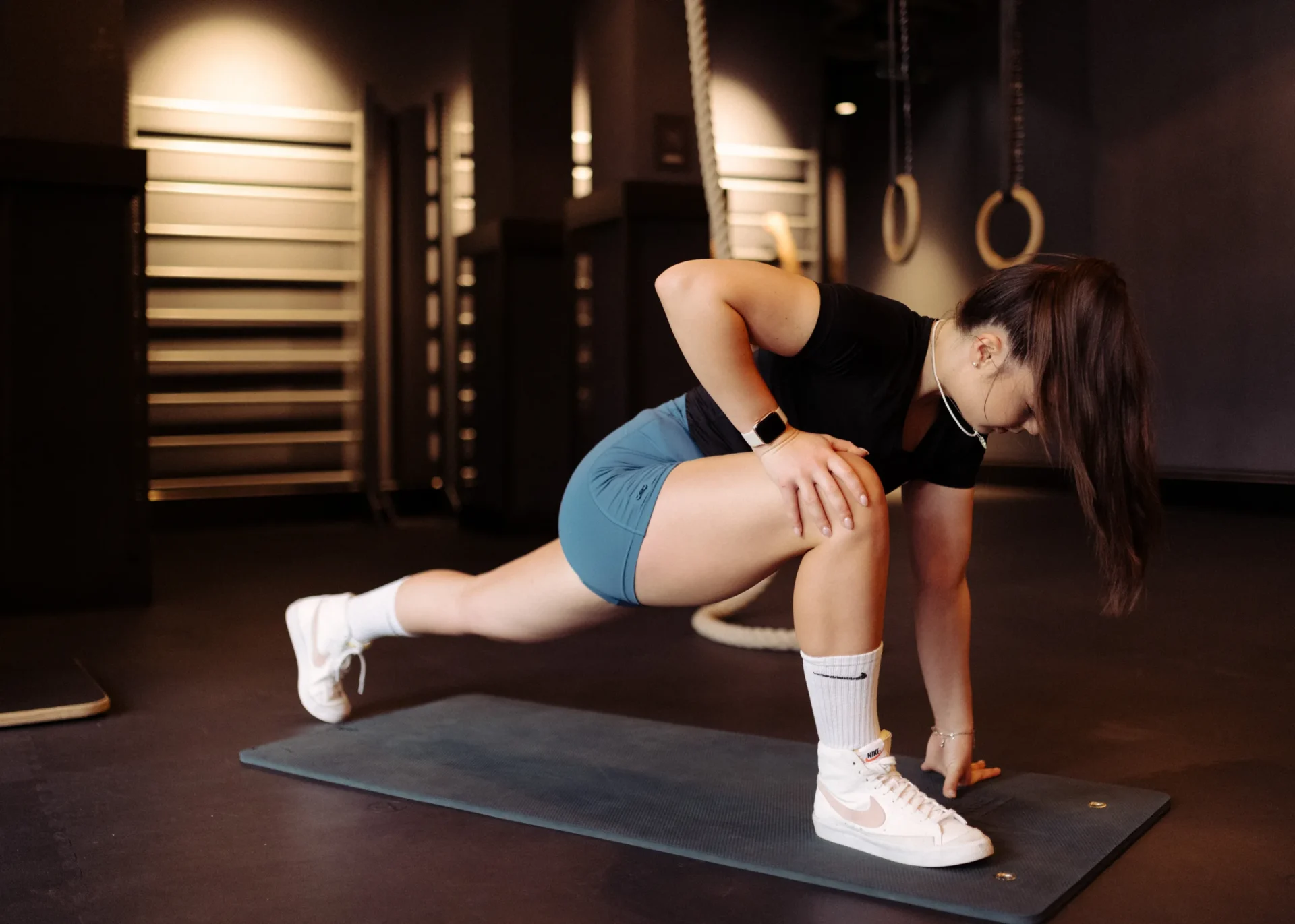 Woman doing a warm-up stretch on mat