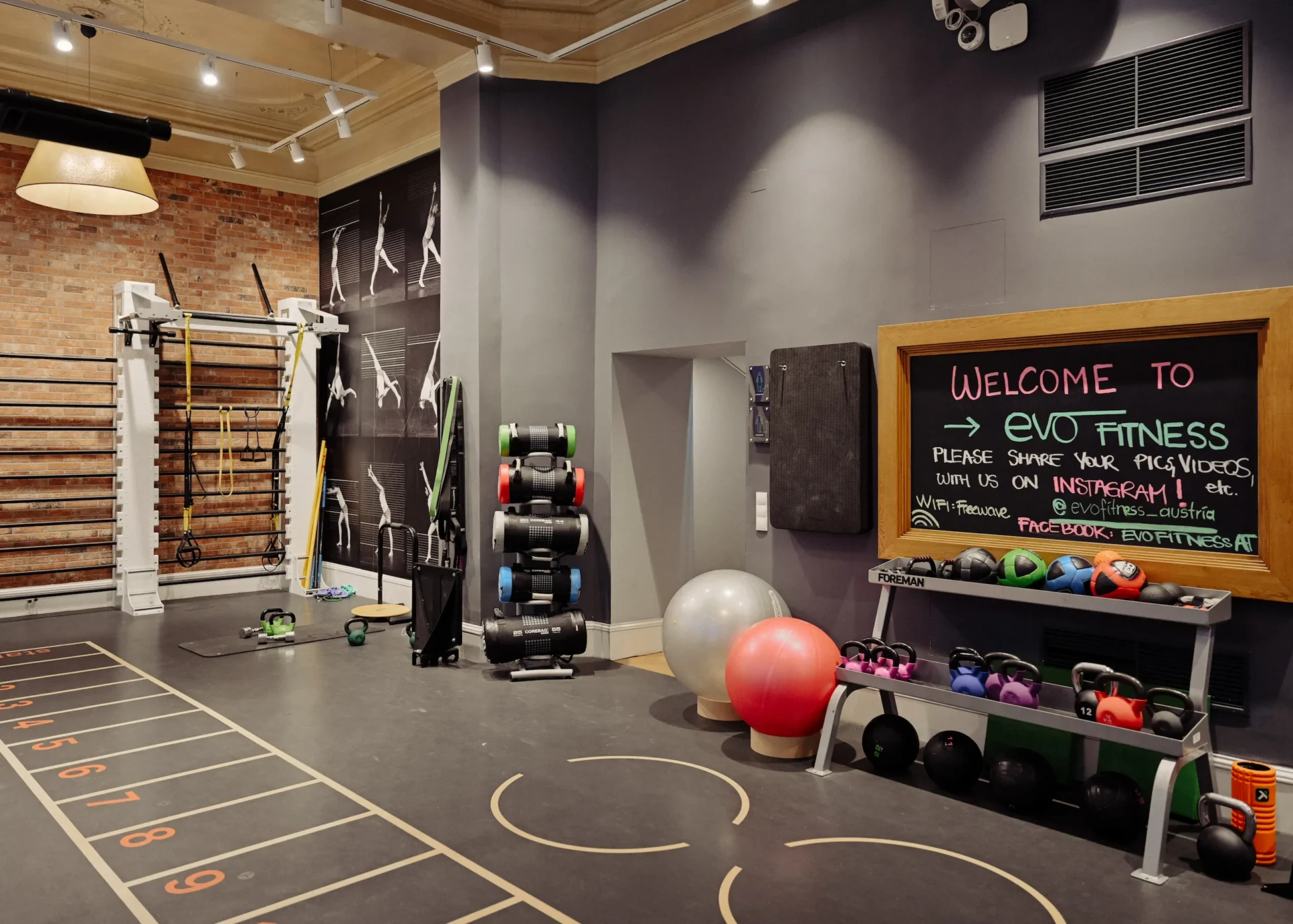 Functional training area with equipment and welcome board at EVO Fitness