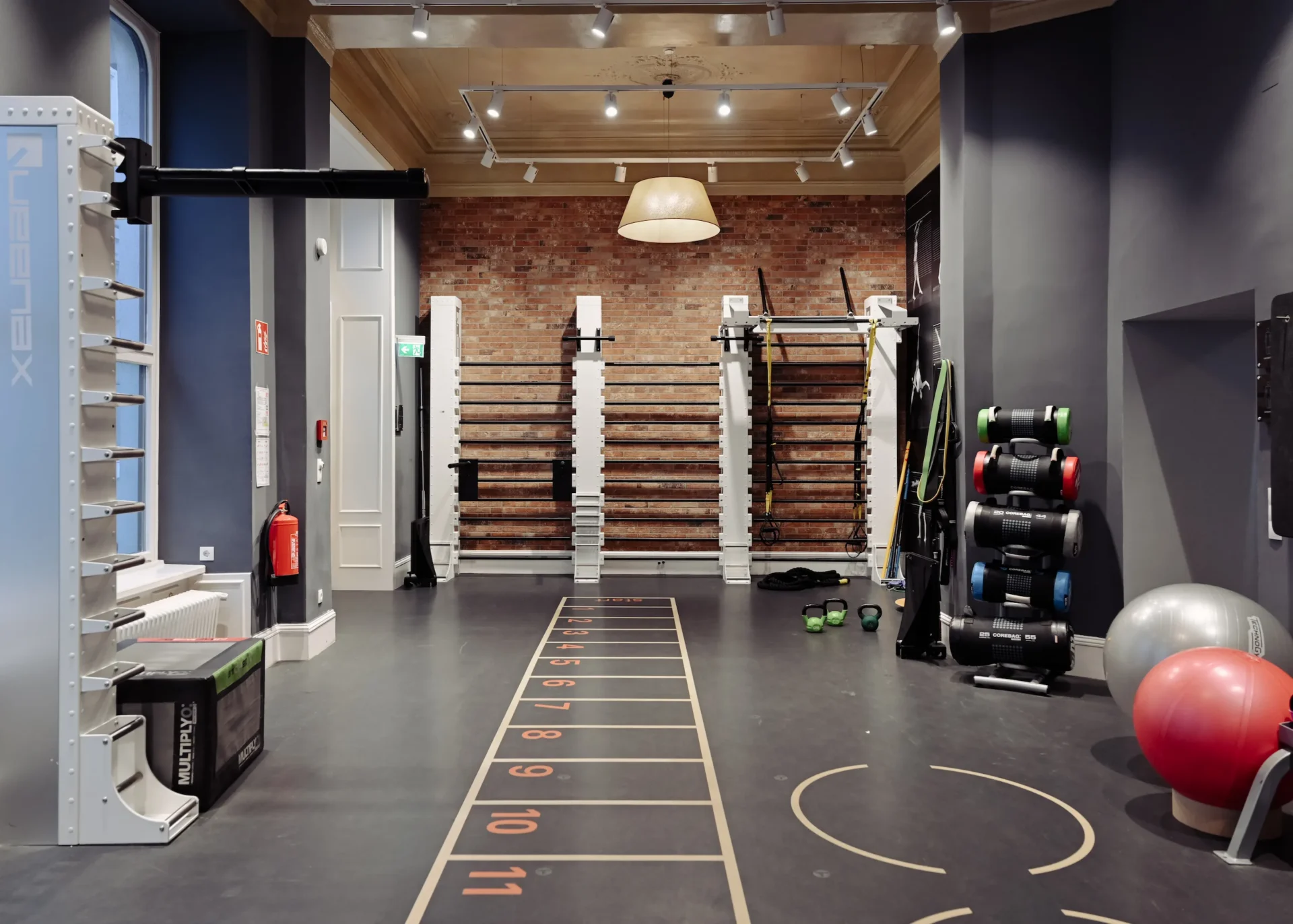 Modern training zone with fitness wall and gym equipment