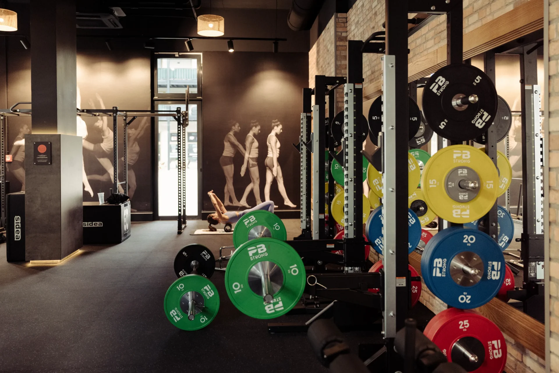 Weightlifting area with colorful PB Strong plates and squat racks at EVO Fitness