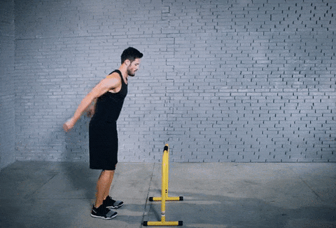 Man jumping over hurdles.