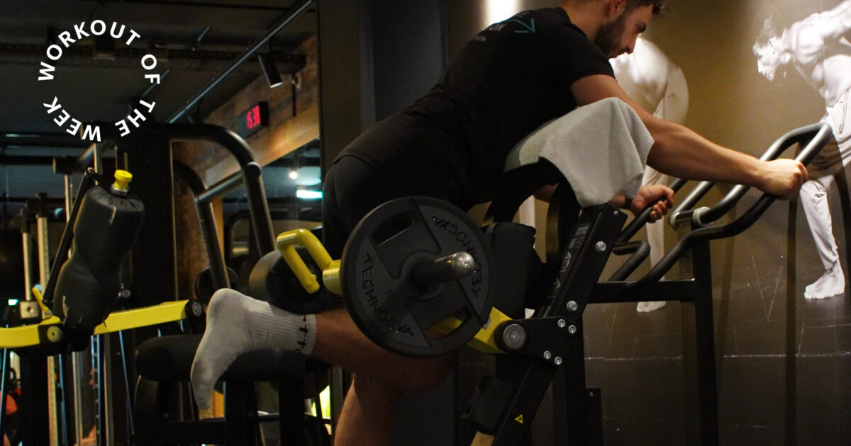 35-min glutes workouT - Man training in the strength area at EVO Fitness using a glute-ham machine with added weight, surrounded by dark lighting and athlete wall art.