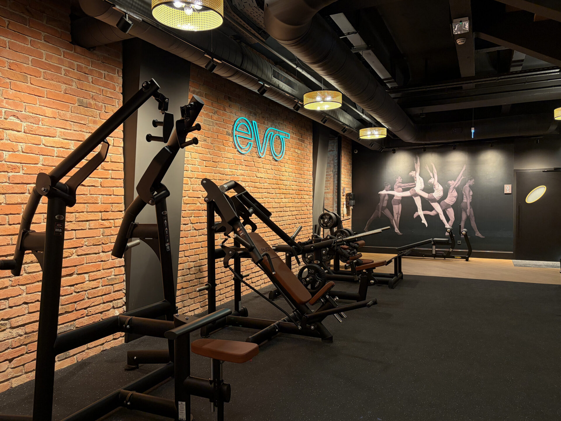 Strength training area with plate-loaded equipment and EVO branding at EVO Fitness Vienna Praterstrasse.